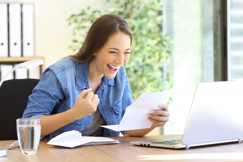 someone looking at their computer and getting excited