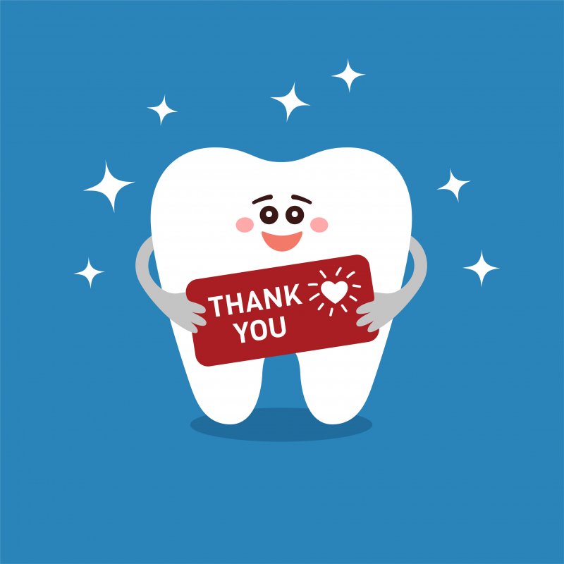 Cartoon tooth holding a sign that says, “thank you.”