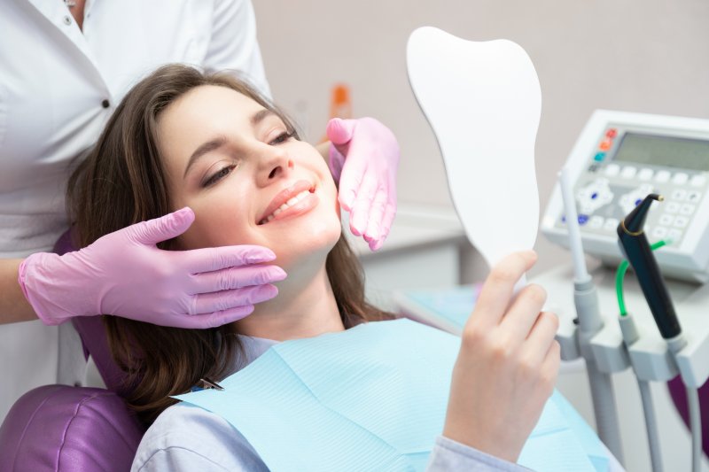A woman smiling after her cosmetic dentistry treatments