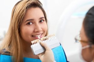 a patient smiling after receiving veneers